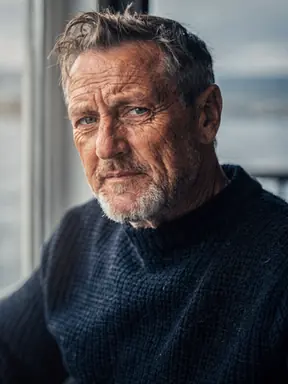 A small, soft low-resolution photograph of a weathered fisherman